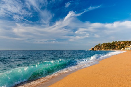 Sea waves and sand main beach at popular holiday resort Lloret de Mar on Costa Brava in the morning , Catalunya, Spainの写真素材