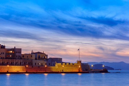 Famouse venetian harbour waterfront of Chania at sunset, Crete, Greeceの写真素材