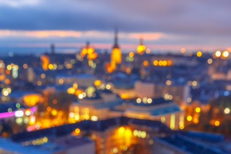Out-of-focus shimmering city background, blurred bokeh photo of old town at sunset, Tallinn, Estoniaの写真素材