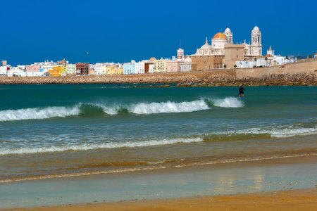 Playa de la Santamaria beach and Cathedral de Santa Cruz in the morning in Cadiz, Andalusia, Spain