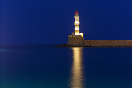 Picturesque view of Lighthouse in old harbour of Chania during twilight blue hour, Crete, Greeceの写真素材