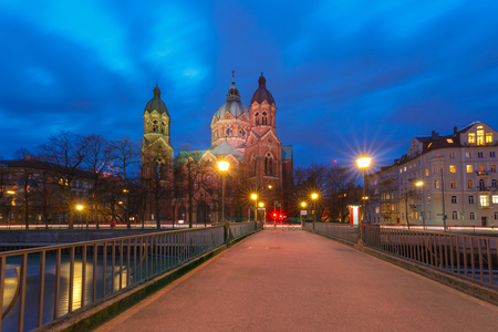 Saint Lucas Church, the largest Protestant church in Munich, and bridge across Isar River at night, Bavaria, Germanyの写真素材