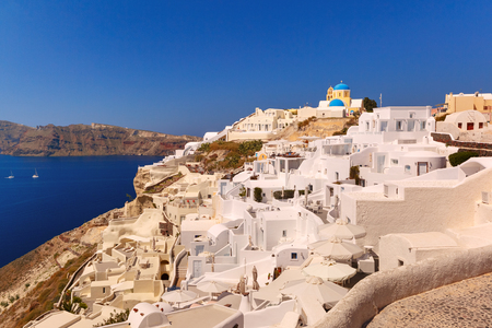 Typical Greek church and white houses in Oia or Ia on the island Santorini, Greeceの写真素材