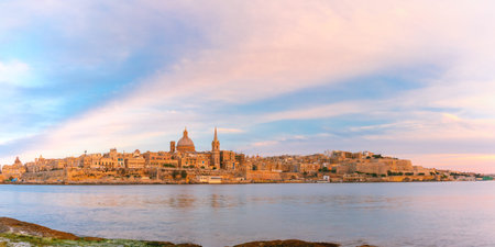 Panoramic view of Valletta Skyline at beautiful sunset from Sliema with churches of Our Lady of Mount Carmel and St. Pauls Anglican Pro-Cathedral, Valletta, Capital city of Maltaの写真素材