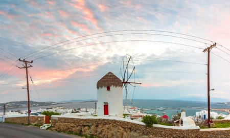 Panoramic aerial view of Mykonos City, Chora with White Windmill and Old Port at gorgeous sunset on the island Mykonos, The island of the winds, Greeceの写真素材