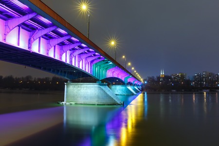 Christmas lighting of Slasko-Dabrowski Bridge in Old Town with reflection in the Vistula River at night, Warsaw, Poland.の写真素材