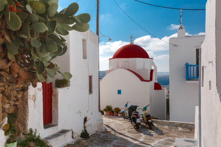 Traditional church with red dome and whitewashed facade, typical Greek church building on the island...