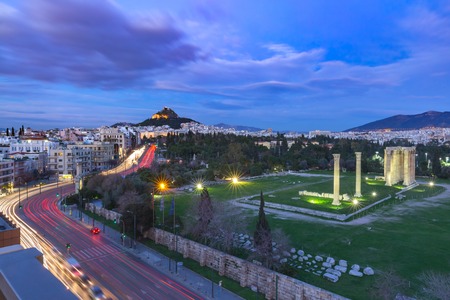 Aerial panoramic view with Ruins and a columns of the Temple of Olympian Zeus, Mount Lycabettus at night, Athens, Greeceの写真素材