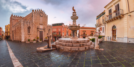Cathedral of Taormina and fountain on the square Piazza Duomo in Taormina at rainy night, Sicily, Italyの写真素材