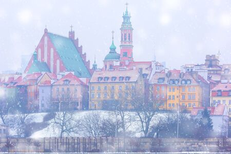 Royal Castle and colorful houses by the Vistula River in the snowy evening, Warsaw, Poland.の写真素材