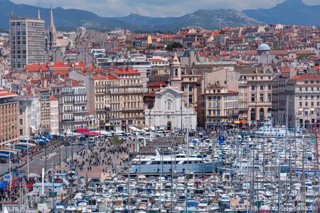 The old Vieux Port and Church of Saint Ferreol - Augustinians in the historical city center of Marseilles on sunny day, Franceの写真素材