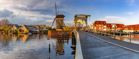 Panorama of Leiden canal Galgewater with De Put windmill and Rembrandt Bridge, South Holland, Netherlandsの写真素材