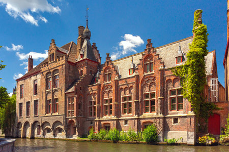 Scenic cityscape with medieval Green canal, Groenerei, in Bruges, in sunny morning Belgiumの写真素材