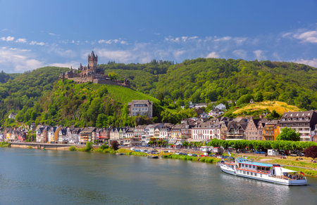 View of sunny Cochem with Reichsburg castle, beautiful town on romantic Moselle river, Germany