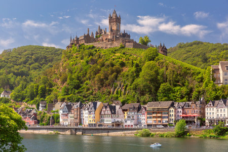 View of sunny Cochem with Reichsburg castle, beautiful town on romantic Moselle river, Germany