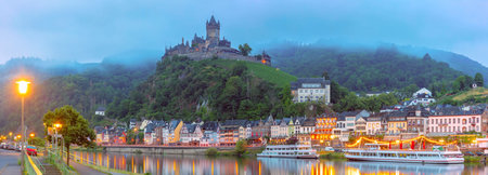 Panorama of Foggy Cochem, beautiful town on Moselle river, Reichsburg castle on hill, Germany