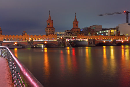 View of the old historic stone Oberbaum bridge over the Spree river in Berlin at sunset. Germany.の写真素材