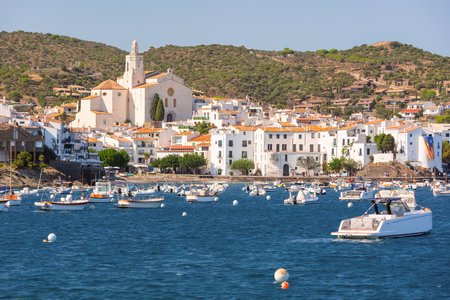 View of Cadaques Bay with small boats on the water, whitewashed houses, Santa Maria Church, Spainの写真素材