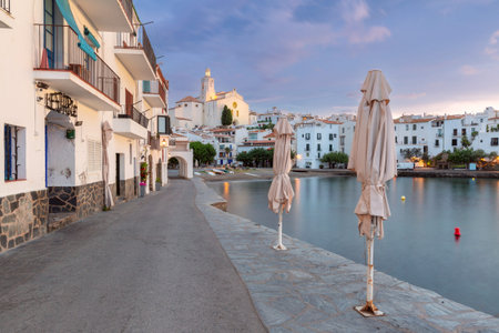 Early morning view of the Cadaques waterfront and Church of Santa Maria in the background, Spain