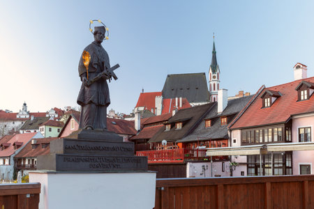 Statue of St John of Nepomuk and church of St Vitus in Cesky Krumlov Czech Republicの写真素材