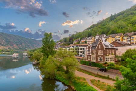 Residential buildings along the Moselle river with hills in Cochem, Germanyの写真素材