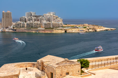 Manoel Island and modern buildings of Sliema seen from Valletta Malta with boats on Marsamxett Harbourの写真素材