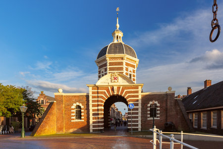 Morspoort city gate in Leiden Netherlands with dome and archway in sunlightの写真素材