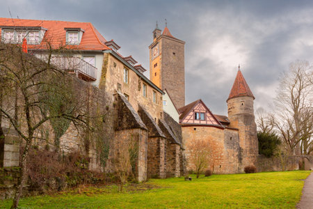 Historic city wall and medieval tower in Rothenburg ob der Tauber Germany with cloudy skyの写真素材