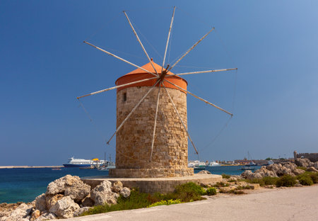 Stone windmills along Mandraki harbor promenade in Rhodes, Greeceの写真素材