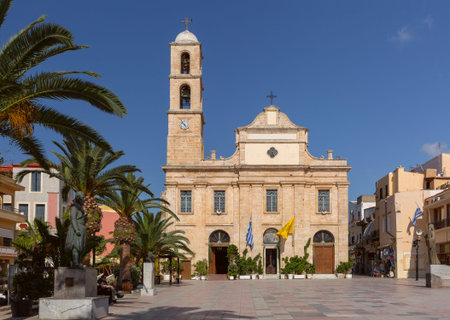 Cathedral church on the main square of Chania with palm trees and traditional buildings, Crete island, Greece, under clear blue skyの写真素材