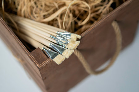 New wooden paint brushes set on light background.の写真素材