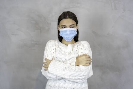 Sick woman in medical mask isolated on grey background.の写真素材