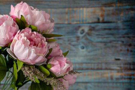 bouquet of pink peonies on blue wooden backgroundの写真素材