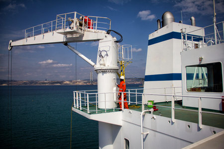 A large tanker kargo ship is being renovated and painted in shipyard dry dock