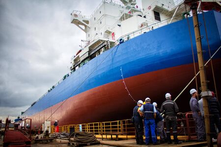 launching of renovated tanker kargo ship from dock to waterの写真素材