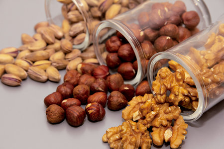 hazelnut, walnut and pistachio nut. mixed assorted nuts in glass box on light background