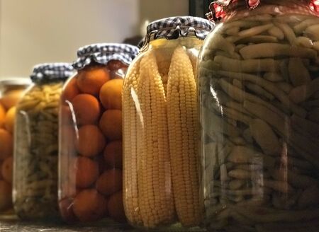 jars of pickled marinated salted vegetables preserves in glass jarsの写真素材