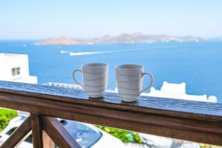 two coffee cup coffee cups in wooden balcony terrace with sea view.