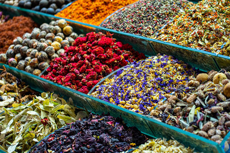 Various bright colored powder spices and fruit herbal tea and dryied vegetables on market in...