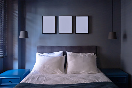 Modern bedroom in luxury apartment in dark blue colors with picture foto frames.の写真素材