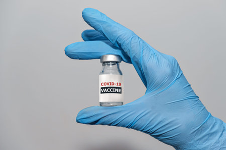 COVID-19 Coronavirus Vaccine in doctor hand with protective gloves