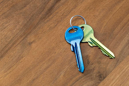 keys on wooden table background. rent sell buy apartment estate businessの写真素材
