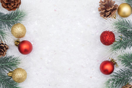 Christmas composition of Christmas tree toy red and gold ball snow background tree branch cone