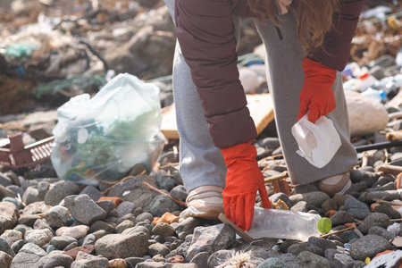 environmental protection concept. young volunteer remove garbage plastic and paper waste bottles trash. ecology pollution problemの写真素材