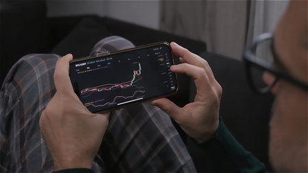 caucasian man at home trade and earn money on the cryptocurrency exchange online using his...