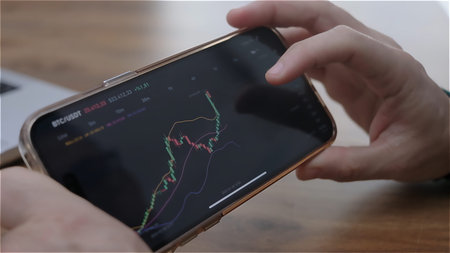 stock market chart with green and red candlesticks going up and down indicating crypto rising in value. trading app showing volumes and time intervals of cryptocurrency price historyの写真素材