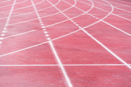 Markings from curve and straight crossed lines on all-weather running track with rubberized surface...