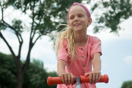 A joyous child on a seesaw in an urban parks playground, sharing smiles and laughter while having a delightful time.の写真素材