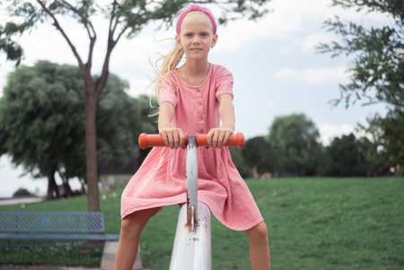 Playful child on seesaw, sharing smiles and laughter in urban park playground fun.の写真素材