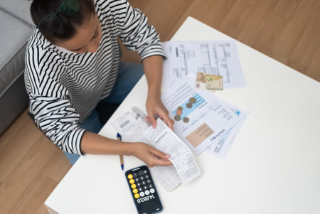 Lady does paperwork at home office calculating regular payment by loan mortgage contract accountant...